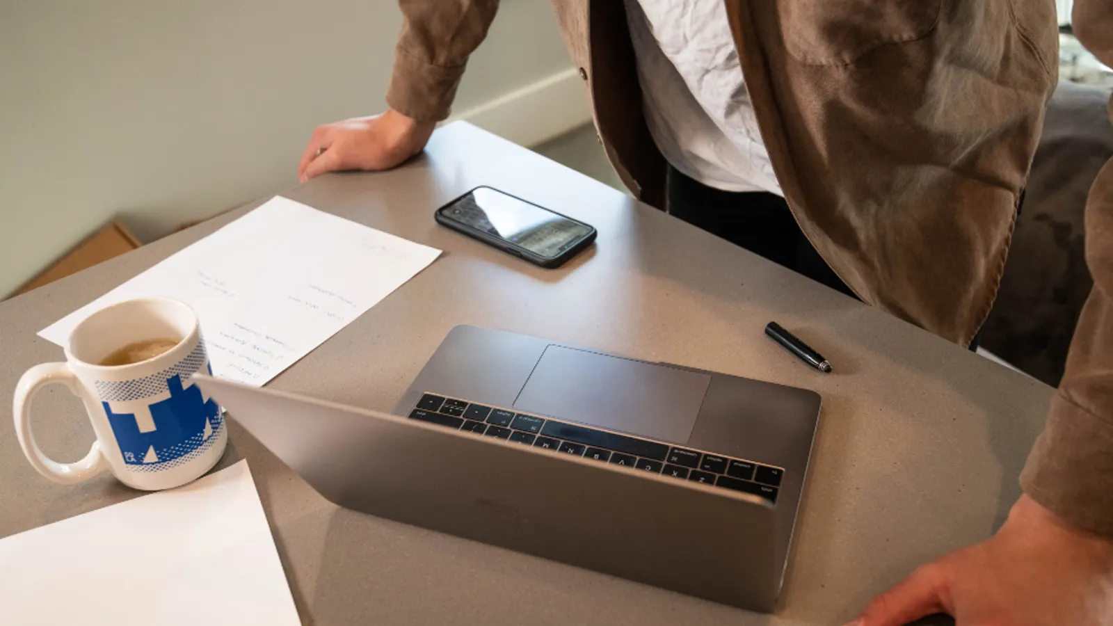 A salesperson asking a question across a desk while a client considers the answer.