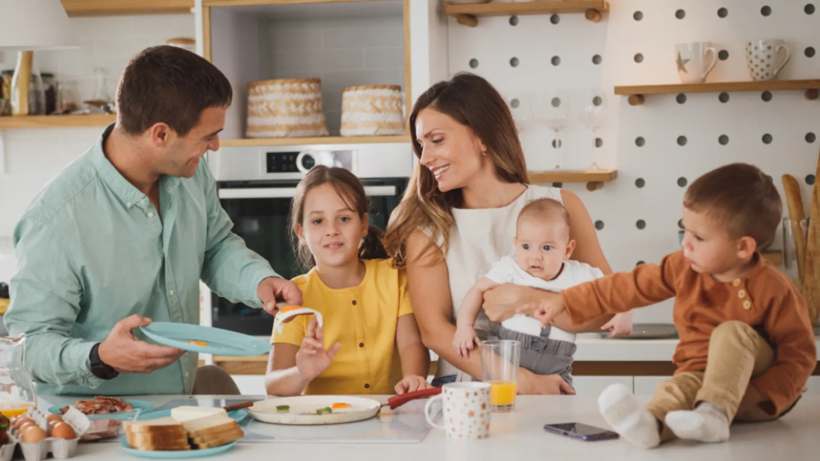 An insurance agent reviewing a policy quote with a couple at their kitchen table.