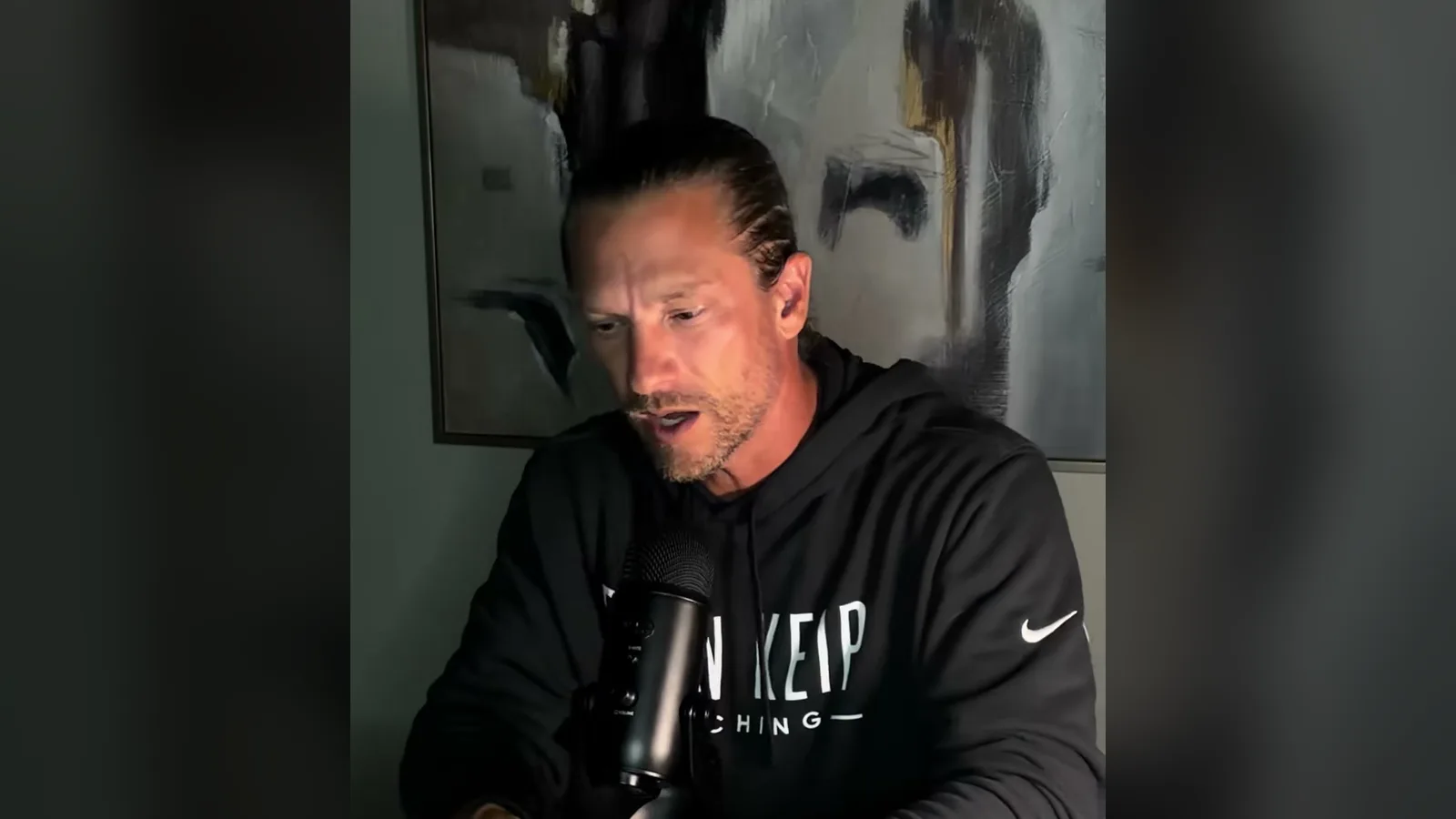Ryan Keip in a black hoodie at a studio microphone while explaining his 4x4 Rule for sales discovery.